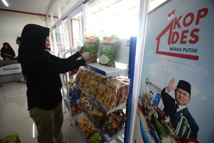 Business hours: An employee arranges on Jan. 22, 2026 premium rice products for sale at a Red and White rural cooperative in Metuk village, Boyolali regency, Central Java.