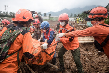 Rescuers recover the body of a victim buried by a landslide in Pasirlangu village in Cisarua, West Bandung regency, West Java, on Jan. 26, 2026. The death toll in a massive Indonesian landslide hit 44 on Jan. 30 as rescuers used heavy equipment to hunt for dozens still missing days after heavy rains unleashed a torrent of mud.