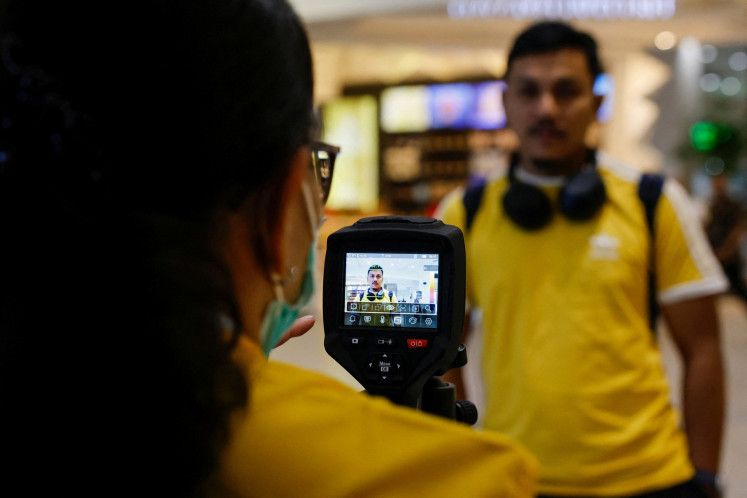 A passenger is checked with a thermal imager at the Soekarno-Hatta International Airport in Tangerang, Banten on Jan. 30, 2026, following the implementation of health screening for arriving passengers, after India confirmed two cases of the deadly Nipah virus.