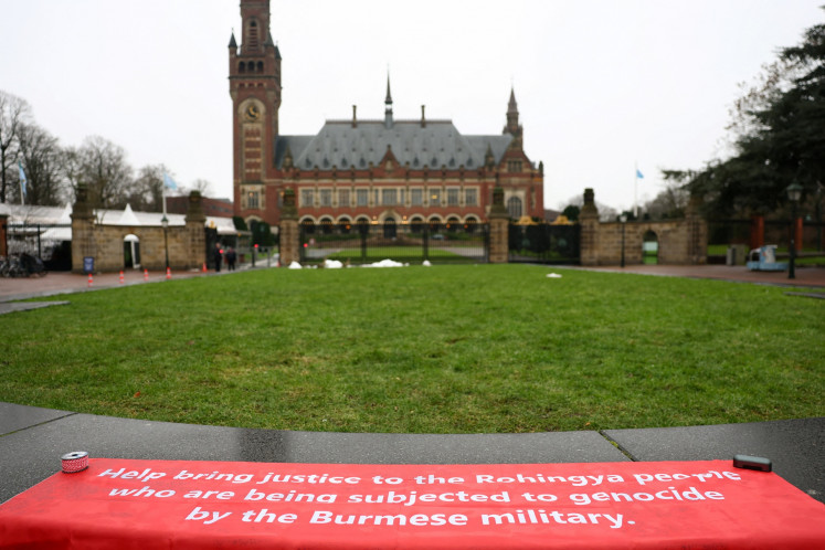 A banner in support of the Rohingya people is seen outside the International Court of Justice (ICJ) in The Hague, Netherlands on Jan. 17, 2026, as the court starts two weeks of hearings in a landmark case brought by Gambia, which accuses Myanmar of committing genocide against the Rohingya, a minority Muslim group.