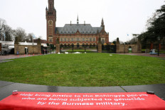 A banner in support of the Rohingya people is seen outside the International Court of Justice (ICJ) in The Hague, Netherlands on Jan. 17, 2026, as the court starts two weeks of hearings in a landmark case brought by Gambia, which accuses Myanmar of committing genocide against the Rohingya, a minority Muslim group.
