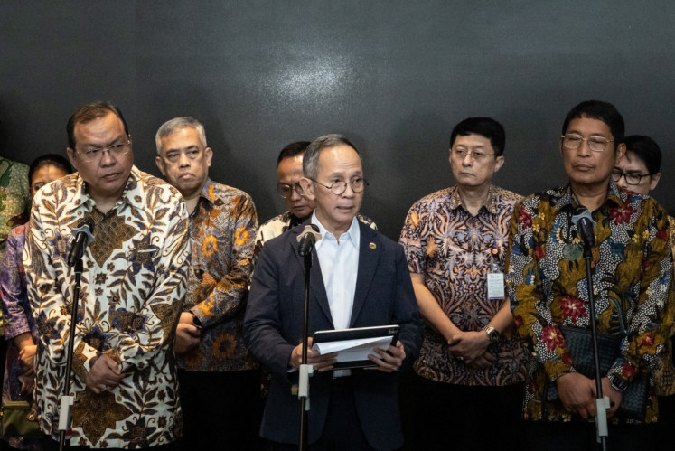 Financial Services Authority (OJK) chairman Mahendra Siregar (front row, center) speaks to the media at the Indonesia Stock Exchange (IDX) in Jakarta on January 29, 2026, following a market collapse triggered by an MSCI warning over transparency and trading manipulation. Mahendra along with IDX president director Iman Rachman (front row, left) and OJK commissioner Inarno Djajadi (front row, right) and deputy commissioner I.B. Aditya Jayaantara (back row, second from right) announced their resignation on the next day. 