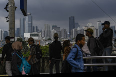 Black sky: Thick clouds cover residential areas and high-rise buildings on Jan. 23, 2026, in Jakarta.