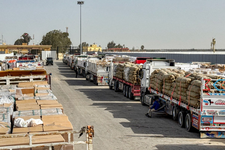 Trucks transporting humanitarian aid wait to enter through the Egyptian side of the Rafah border crossing with the Gaza Strip in northeastern Egypt on Jan. 27, 2026, as the vital crossing to the Palestinian territory reopens. The Rafah crossing between Gaza and Egypt is the Palestinian territory's only gateway to the outside world that does not lead to Israel and is a key entry point for both people and goods.