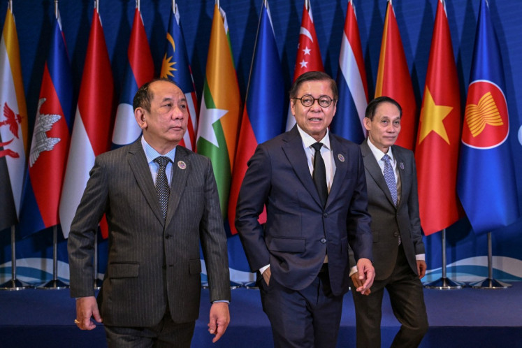 Myanmar's Permanent Secretary of the Ministry of Foreign Affairs Hau Khan Sum (left) walks with Thailand's Minister of Foreign Affairs Sihasak Phuangketkeow (center) and Vietnam's Foreign Minister Le Hoai Trung after the group photo during the ASEAN Foreign Ministers' Meeting (AMM) in Cebu City, the Philippines on Jan. 29, 2026.