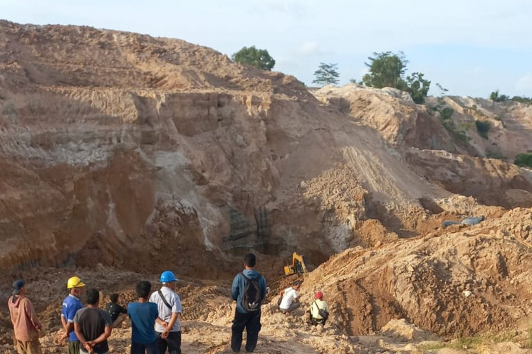 Search and rescue workers observe a landslide scar on Jan. 3, 2026 at the Pondi illegal tin mining site in Pemali district, Bangka regency, Bangka Belitung Islands. The landslide, on Jan. 2, killed six workers, with one still missing. 