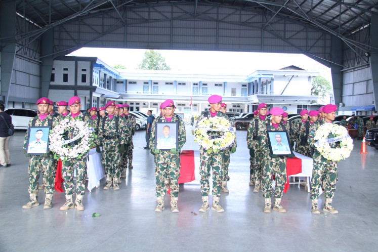 A guard of honor from the Indonesian Navy's Marine Corps escorts the coffins carrying the bodies of First Pvt. Burton C. Silitonga, Chief Pvt. Dicky Yogha Priambada and Second Cpl. Anton Karisma on Feb. 3, 2026, during a military send-off ceremony at Pondok Cabe Naval Air Base in South Tangerang, Banten. The three "Black Bears" riflemen were killed in a landslide on Jan. 24 while training in Cisarua, West Bandung, West Java.