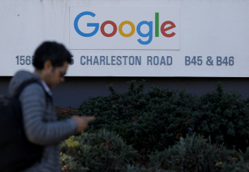 A pedestrian walks by a sign at Google headquarters on Feb. 4, 2026, in Mountain View, California, United States. Google parent company Alphabet reported better-than-expected fourth-quarter results, with revenue rising 18 percent from a year earlier Getty Images/AFP (Photo by JUSTIN SULLIVAN / GETTY IMAGES NORTH AMERICA / Getty Images via AFP)