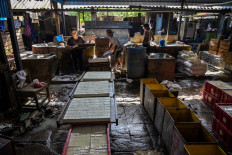 Workers make tofu at a factory in Surabaya, East Java, on Feb. 5, 2026. 