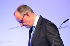 German Chancellor Friedrich Merz looks down as he leaves after delivering a speech on Monday, Feb. 2, 2026, at the annual reception of the stock exchange operator Deutsche Boerse in Eschborn, western Germany.