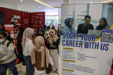 Career talks: A company booth attendant responds to inquiries from visitors on Jan. 29, 2026, during a job and career fair at the Muladi Dome within the premises of Diponegoro University in Semarang, Central Java. 