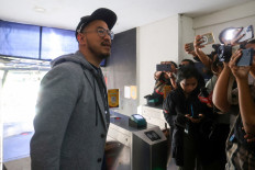 Comedian Pandji Pragiwaksono talks to journalists after he was summoned by the Jakarta Police over what they called public complaints about the material he used in his stand-up act in Jakarta on Feb. 6, 2026.