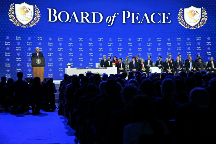 United States President Donald Trump (left) speaks at the Board of Peace launch during the World Economic Forum (WEF) annual meeting in Davos, Switzerland, on Jan. 22, 2026. 
