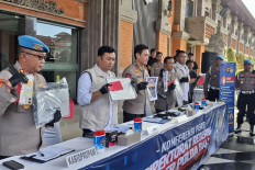 Bali Police chief Insp. Gen. Daniel Adityajaya (center) and other officers show evidence from an online gambling network run by Indians on Feb. 7, 2026, during a press conference at Bali Police heaquarters in Denpasar. Police have named 35 suspects and four witnesses in the case.