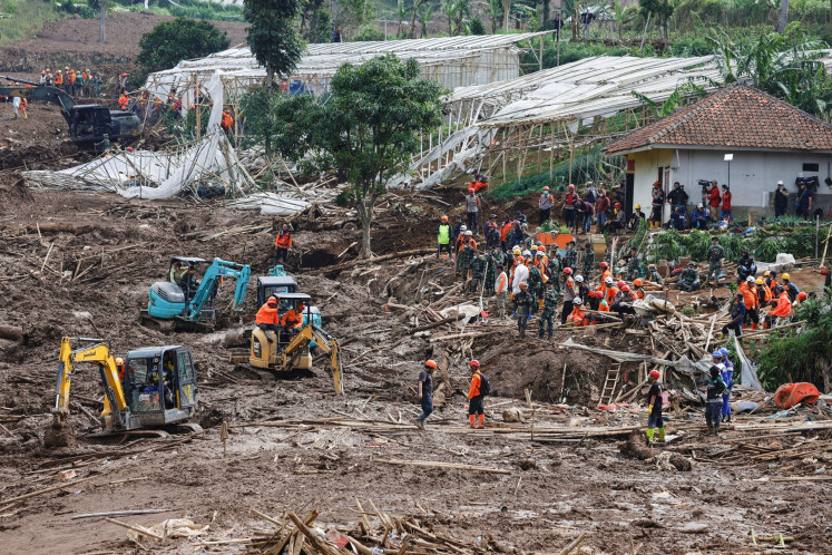 Joint search and rescue personnel search for victims on Jan. 27, 2026, at the site of a landslide following heavy rains in Pasir Langu village, Cisarua district West Bandung regency, West Java.