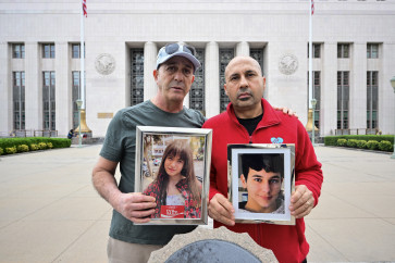 Parents hold photos of their children outside the Los Angeles County Superior Court in Los Angeles, US, on Feb. 9, 2026, ahead of a landmark US trial that could establish a legal precedent on whether social media companies deliberately designed their platforms to lead to addiction in children.