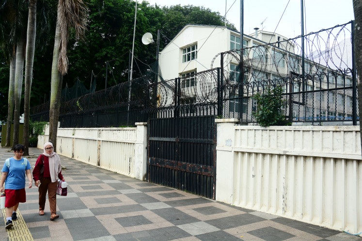 Residents walk past the former British Embassy building on Feb. 10, 2026, near the Hotel Indonesia (Bundaran HI) traffic circle in Jakarta. President Prabowo Subianto previously announced the allocation of a 4,000-square-meter plot at the site for the construction of a 40-story Indonesian Ulema Council (MUI) skyscraper, dubbed the &ldquo;Umat Building&rdquo;, which will house various Islamic groups.