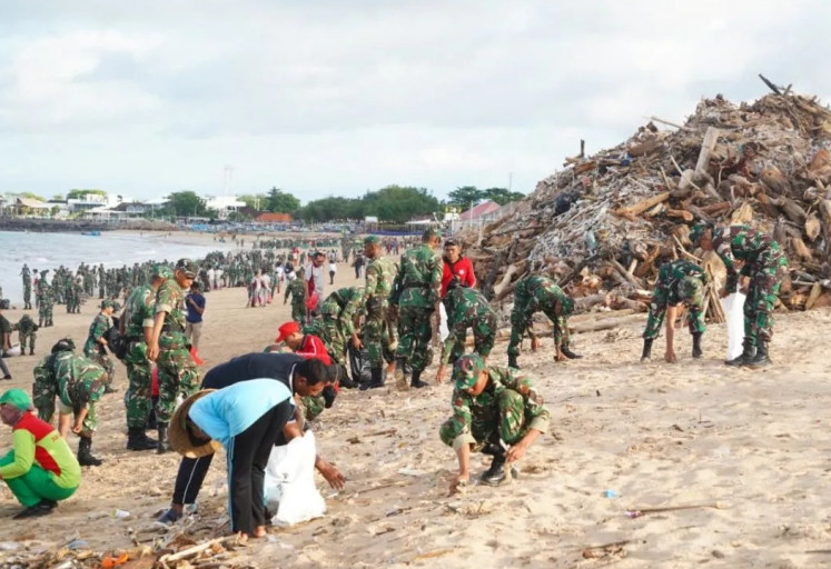 Hundreds of people, including students, and military and police personnel, participate in the cleanup campaign on Feb. 3, 2026, at Kuta Beach in Badung regency, Bali. 

