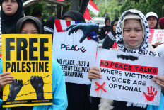 A group of women hold a pro-Palestine rally on Feb. 13, 2026, outside the Palestinian embassy in Menteng, Central Jakarta, calling on the government to withdraw its decision to join the United States-led Board of Peace, an international body to oversee  the Israel-Hamas ceasefire in Gaza.