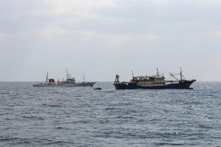 Japanese Fisheries Enforcement Headquarters' fisheries patrol vessel &ldquo;Hakuo Maru&ldquo; (left) and a Chinese fishing vessel (right) sail within Japan's exclusive economic zone off Nagasaki Prefecture, Japan on Feb. 12, 2026. Japanese authorities seized a Chinese fishing boat and arrested its skipper, authorities said on Feb. 13, in a move likely to further heighten tensions with Beijing.