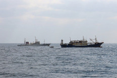 Japanese Fisheries Enforcement Headquarters' fisheries patrol vessel &ldquo;Hakuo Maru&ldquo; (left) and a Chinese fishing vessel (right) sail within Japan's exclusive economic zone off Nagasaki Prefecture, Japan on Feb. 12, 2026. Japanese authorities seized a Chinese fishing boat and arrested its skipper, authorities said on Feb. 13, in a move likely to further heighten tensions with Beijing.