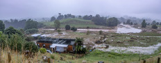 Floodwaters flows through an area affected by heavy rain and wild winds in Puketotara, Waikato region, New Zealand, February 14, 2026 in this picture obtained from social media. 