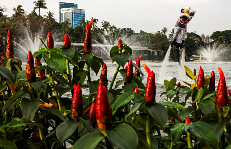 A person uses a flyboard as they perform a lion dance on Feb. 14 at Senayan Park shopping mall, ahead of the Chinese Lunar New Year, which will welcome the Year of the Horse, in Jakarta. 