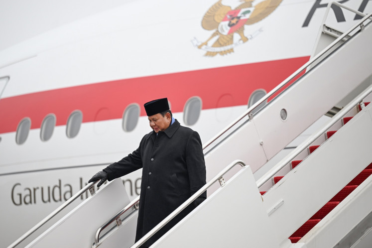 President Prabowo Subianto walks from his plane on Feb. 17 upon arriving at Joint Base Andrews in Maryland, the United States. Prabowo flew to Washington, DC, to attend the inaugural US-led Board of Peace meeting as well as a bilateral meeting with his US counterpart Donald Trump.