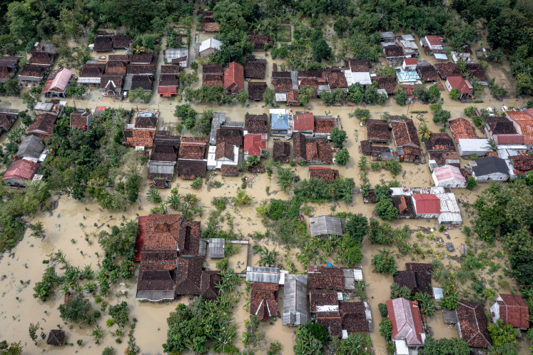 Floodwaters submerge Tinanding Village on Tuesday in Gubug District, Grobogan Regency, Central Java. Torrential rains have caused severe flooding across Grobogan regency, damaging key roads, inundating homes and submerging thousands of hectares of rice fields.
