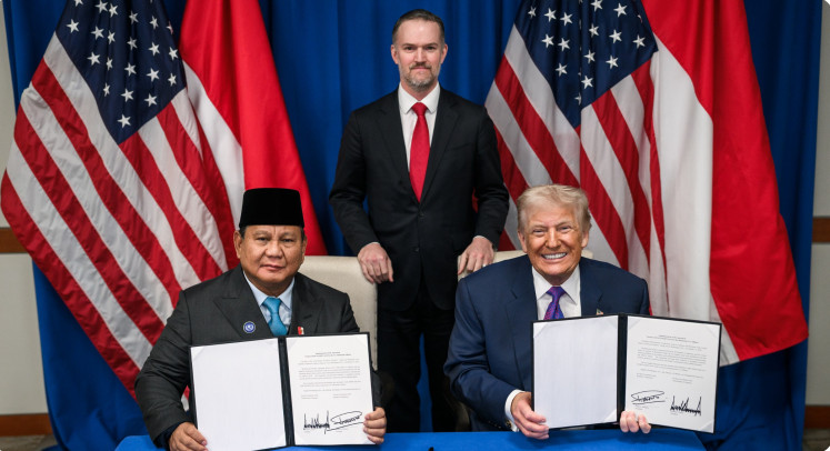 Indonesia President Prabowo Subianto (left) and United States President Donald Trump (right) show the signed trade deal documents in Washington, US, on February 19, 2026, as witnessed by US Trade Representative Jamieson Greer. Indonesia and the US finalized the trade deal that locks in tariff rates and non-tariff barriers to commerce.