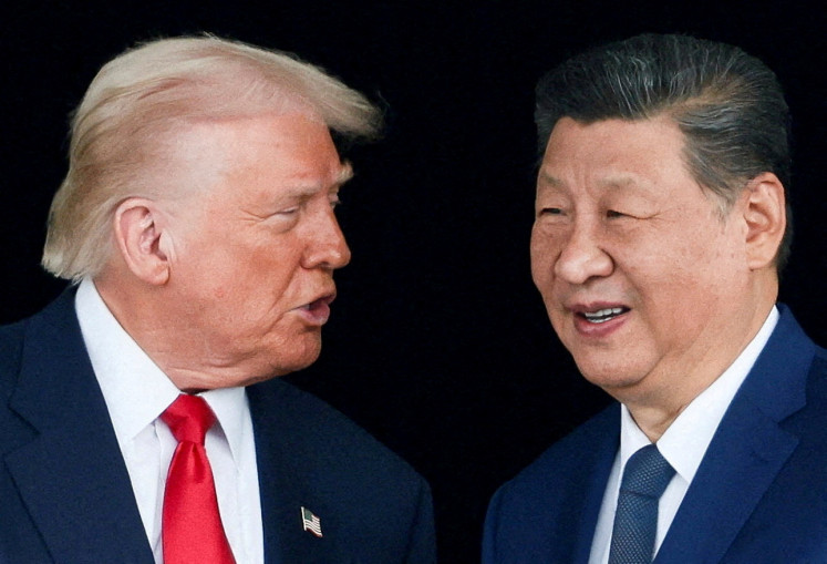 United States President Donald Trump and Chinese President Xi Jinping talk as they leave after a bilateral meeting on the sidelines of the Asia-Pacific Economic Cooperation (APEC) summit in Busan, South Korea, on Oct. 30, 2025.