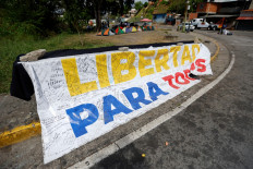 A banner reading 'Freedom for all' is displayed in front of El Rodeo I prison in Guatire, Miranda state, Venezuela, on Feb. 20, 2026. Venezuela's National Assembly on Feb. 19 unanimously approved a long-awaited amnesty law that could free hundreds of political prisoners jailed for being government detractors.