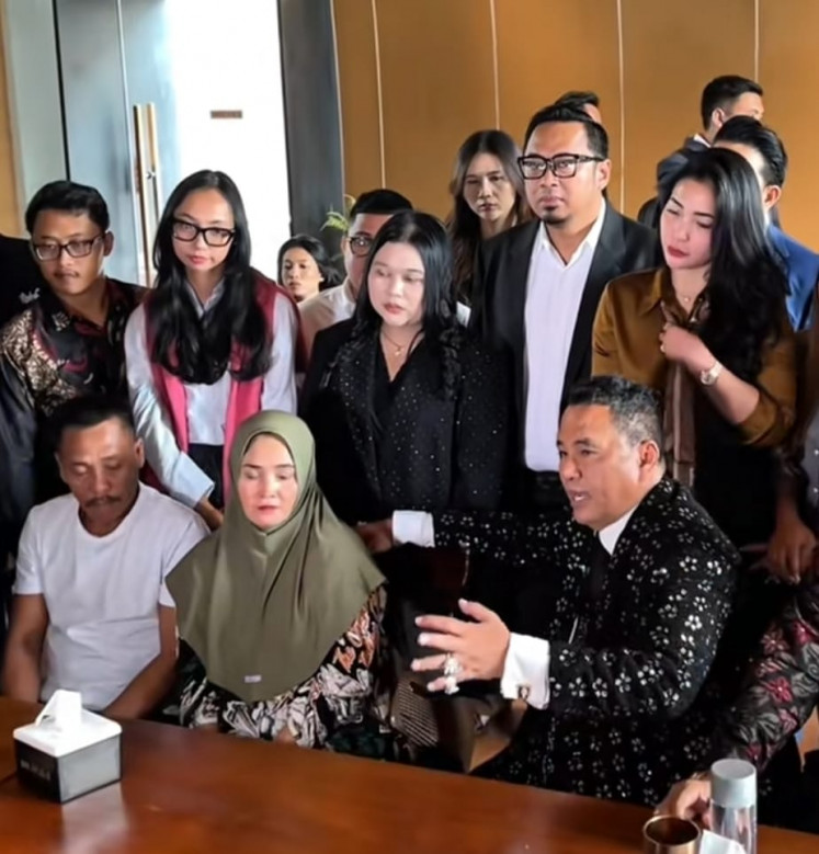 Fandi Ramadan's father Sulaiman (sitting left) and mother (sitting center) listen on Friday as top lawyer Hotman Paris talks during a meeting in Jakarta. Fandi, a ship crew member who had just worked for three days, faces the death penalty in a drug smuggling case.