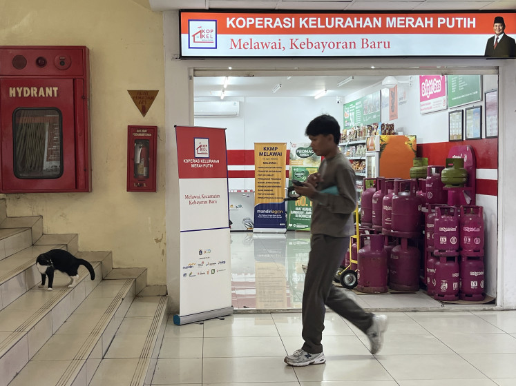 A man walks past a Melawai outlet of the Red and White Cooperatives (KMP) program on Feb. 23, 2026, located in the Blok M shopping and nightlife hub in Kebayoran Baru, South Jakarta.