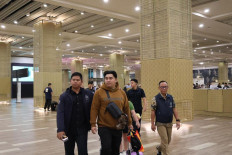 Police officers escort human trafficking suspect Rifaldo Aquino Pontoh (second left) after being arrested at I Gusti Ngurah Rai International Airport in Badung regency, Bali, on Feb. 21, 2025. Rifaldo allegedly used social media accounts to advertise vacancies and promised high salaries in Cambodia to job seekers.