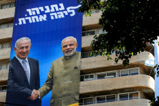 This picture taken on July 28, 2019 shows two giant Israeli Likud Party election banners hanging from a building showing Israeli Prime Minister Benjamin Netanyahu shaking hands with Indian Prime Minister Narendra Modi with a caption above reading in Hebrew &ldquo;Netanyahu, in another league&ldquo;, in the coastal Mediterranean city of Tel Aviv.