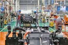 Workers assemble truck parts at a factory in East Karawang, West Java, in this undated file photo. 