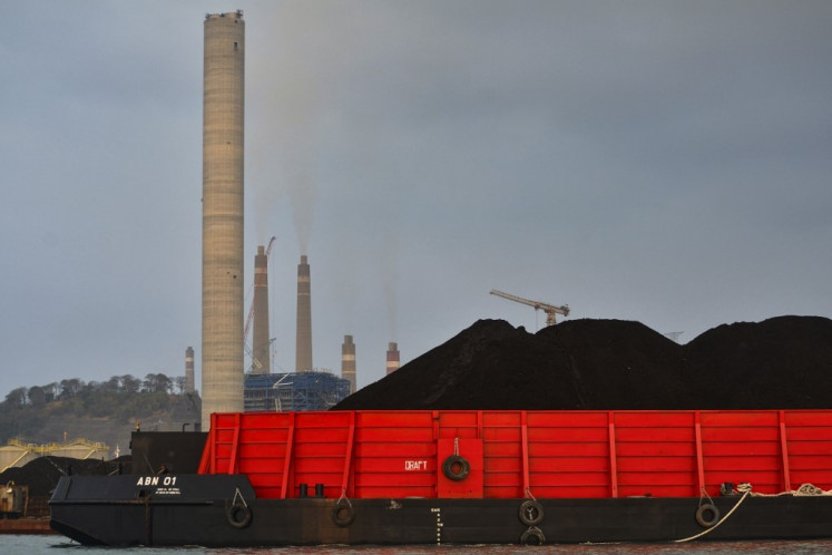 A barge carries coal at the dock next to the Suralaya coal-fired power plant on Oct. 31, 2023, in Cilegon, Banten.