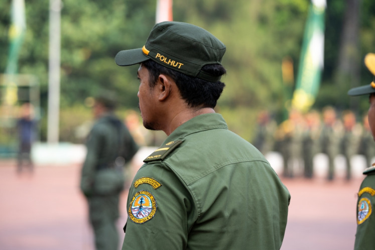 A forest ranger attends a flag-raising ceremony at the Forestry Ministry's office in Jakarta on Dec. 28, 2024.