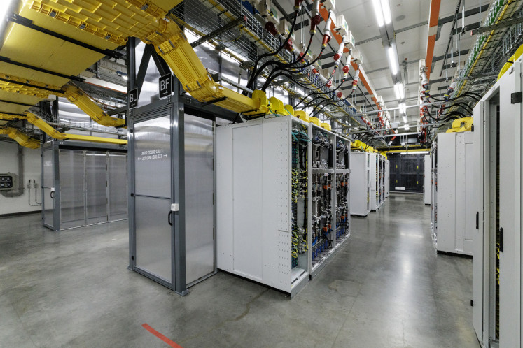 Racks of graphics processing units (GPUs) with a closed-loop liquid cooling system are seen on Feb. 4 inside an operational Microsoft data center in Karawang, West Java.
