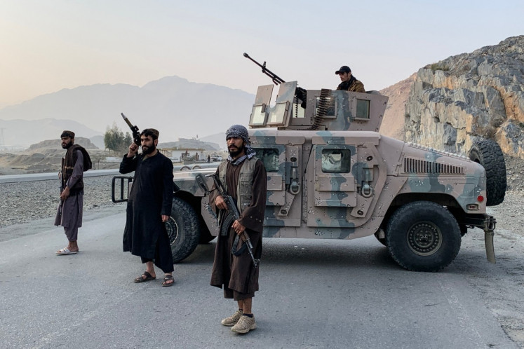 Taliban security personnel stand guard near the Torkham border crossing between Afghanistan and Pakistan in the Nangarhar province on February 27, 2026. 