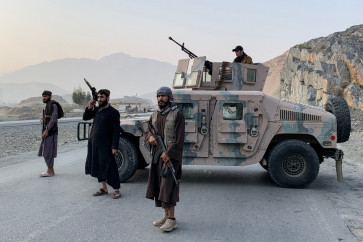 Taliban security personnel stand guard near the Torkham border crossing between Afghanistan and Pakistan in the Nangarhar province on February 27, 2026. 