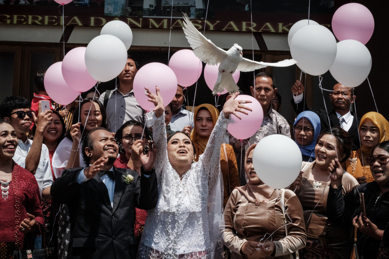 Bride Maria Delsa Visianika (center) and groom Gideon Hermantoko release pigeons on Dec.16, 2023, during their wedding ceremony at the Epivani Java Christian Church in Parakan, Central Java.