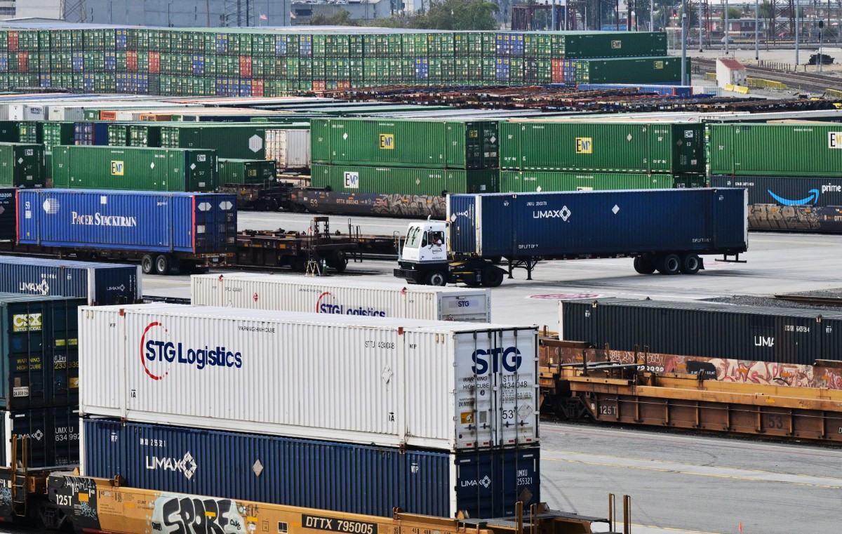 Shipping containers and container trucks seen at the LATC-Union Pacific Los Angeles Transportation Center rail yard on Feb, 24, 2026 in Los Angeles, California, the United States. Fresh US tariffs on imported goods came into effect Feb. 24, as US President Donald Trump moved to rebuild his trade agenda after the Supreme Court ruled against a swath of his global duties.