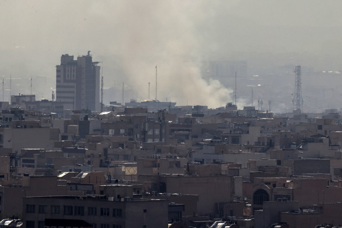 A plume of smoke rises following a reported explosion in Tehran on February 28, 2026. 
