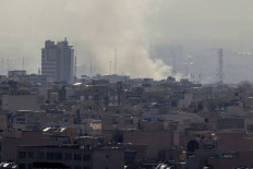 A plume of smoke rises following a reported explosion in Tehran on February 28, 2026. 