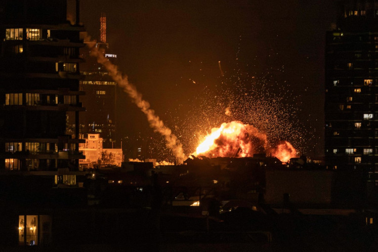A fireball lights the sky following a missile strike on Tel Aviv on February 28, 2026. The United States and Israel launched strikes against Iran on February 28, with Israel's public broadcaster reporting that the Iranian supreme leader had been targeted, as the Islamic republic retaliated with barrages of missiles at Gulf states and Israel. 