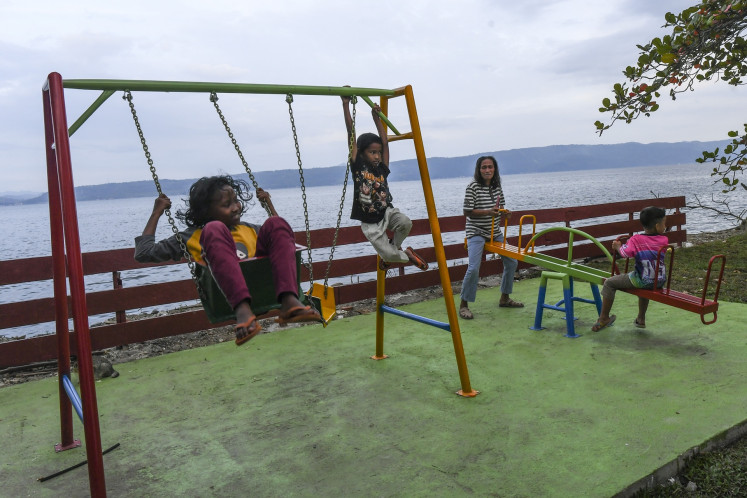 Children play at a playground on Feb. 20 in the Danantara temporary housing site for survivors of cyclone-induced floods and landslides in Tanah Datar regency, West Sumatra. At least 20 families from Guguak village have been staying at the site located next to the Singkarak Lake in the province since Feb. 7.
