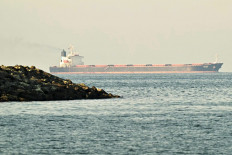 A cargo ship is pictured off coast city of Fujairah, in the Strait of Hormuz in the northern Emirate on February 25, 2026. 