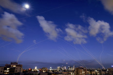 A time exposure photograph shows trails and explosions on Feb. 28, 2026, from projectile interceptions by Israel's Iron Dome missile defense system over Tel Aviv. 